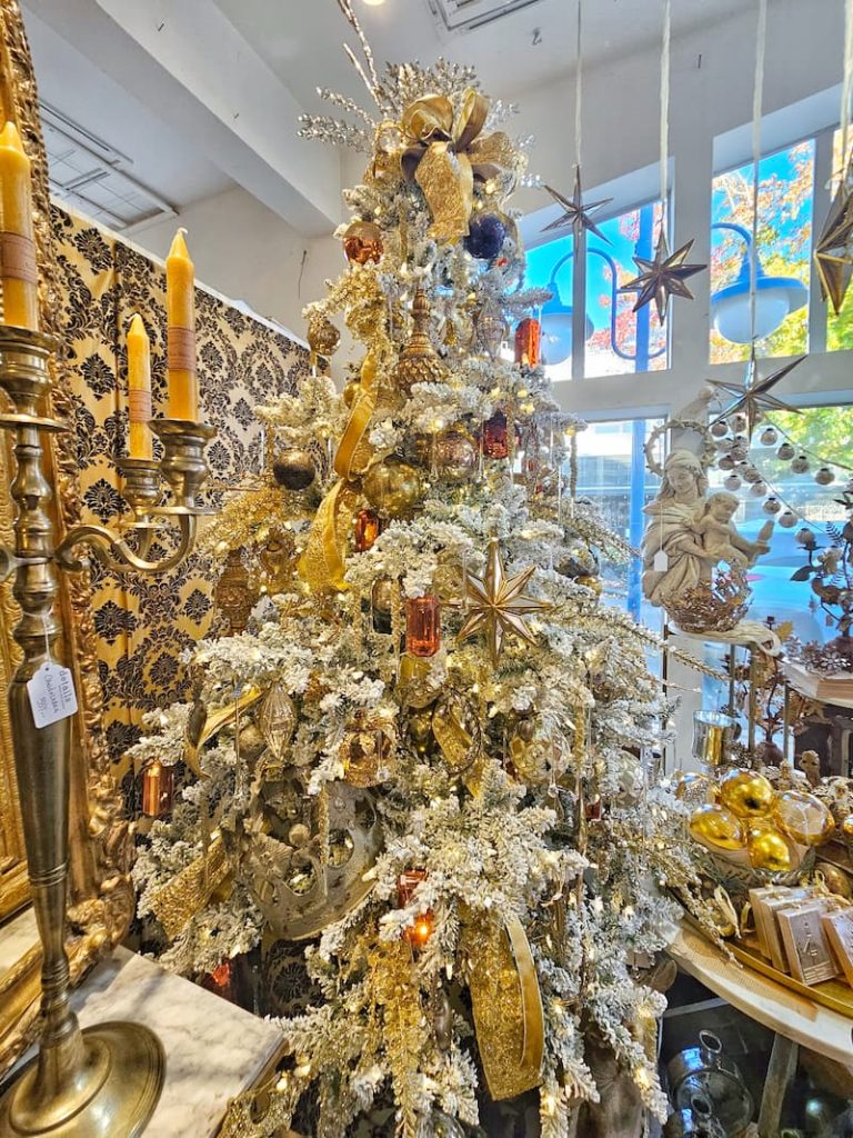 flocked tree with gold ornaments