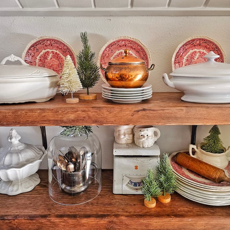 red and white transferware, ironstone, copper, and vintage Christmas decor on open shelving
