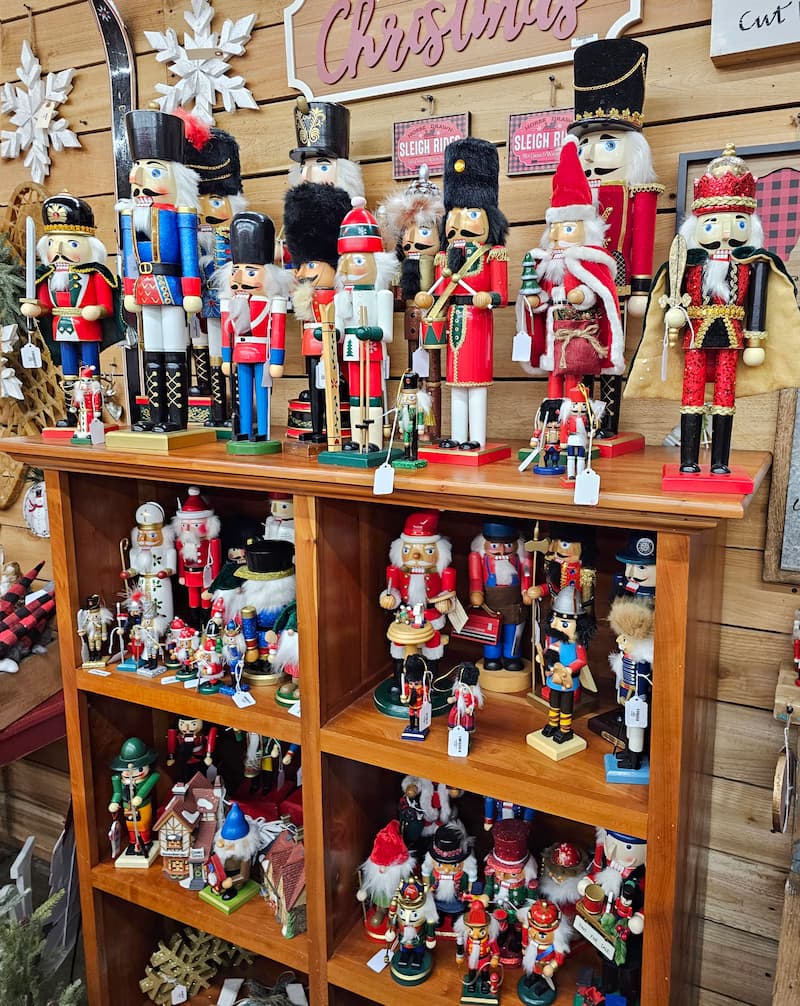 a bookcase filled with many different styles of nutcrackers