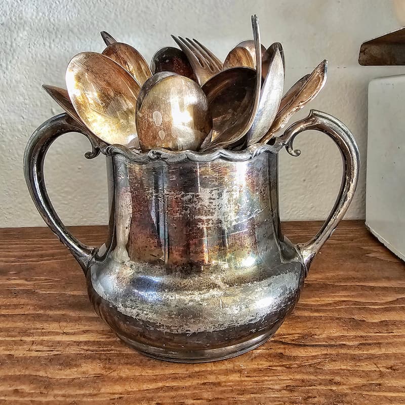 vintage silverware and cup