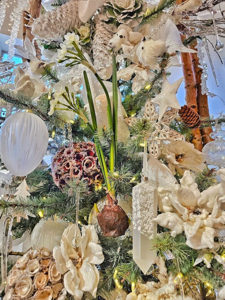 Christmas decor theme: cream flower decorations and faux amaryllis ornaments