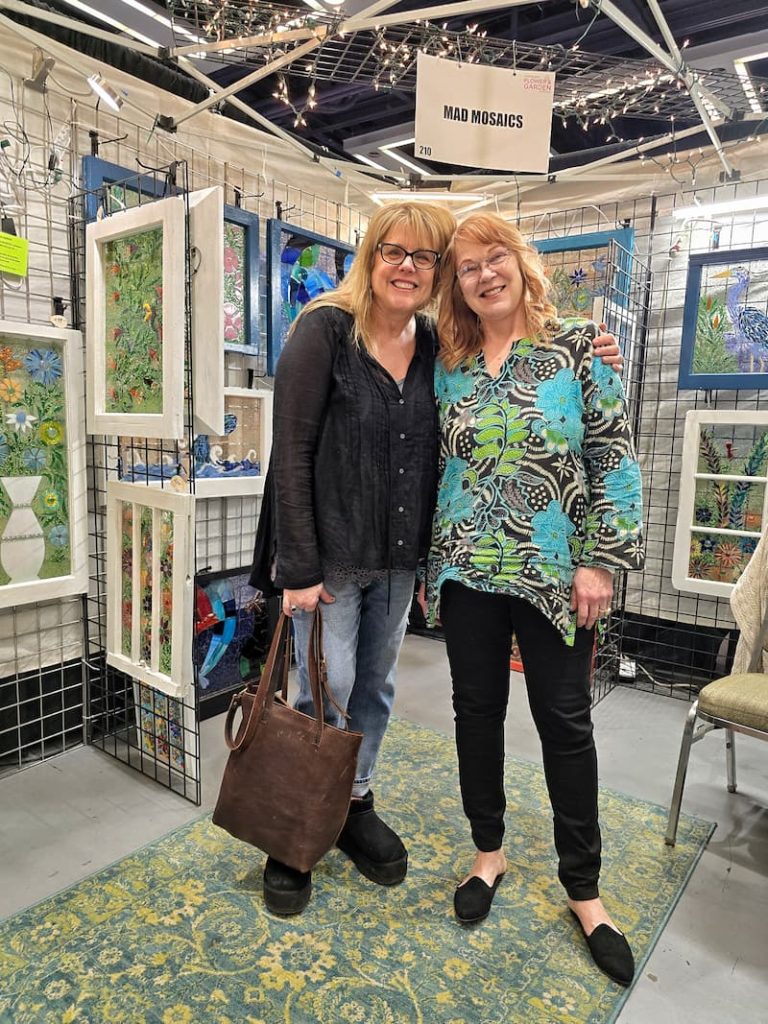 friends standing in the Mad Mosaic booth
