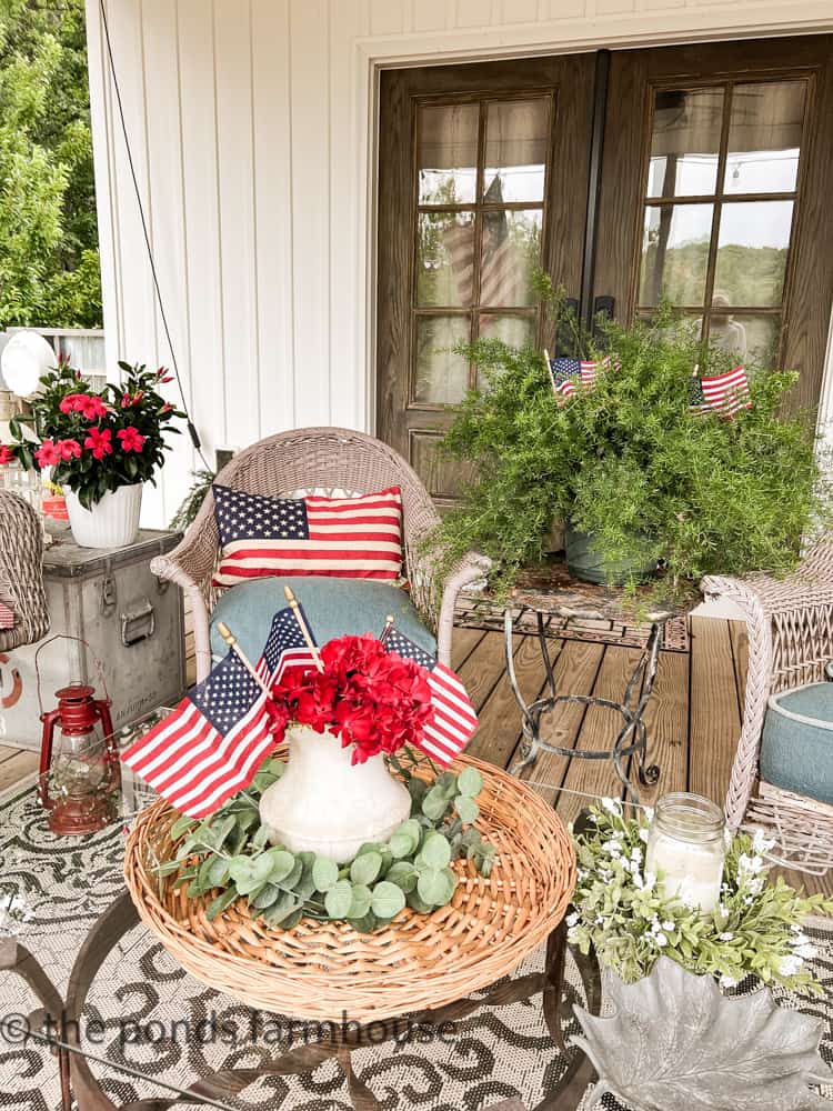American flag pillow and small flags on porch The Ponds Farmhouse