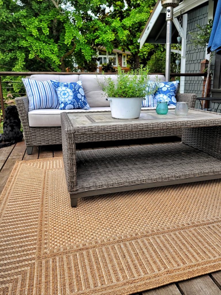 outdoor couch and coffee table with rug on deck