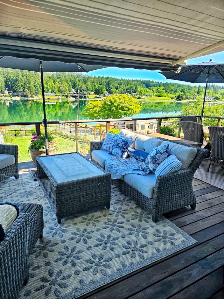 blue and white decorative pillows and outdoor furniture on deck with awning