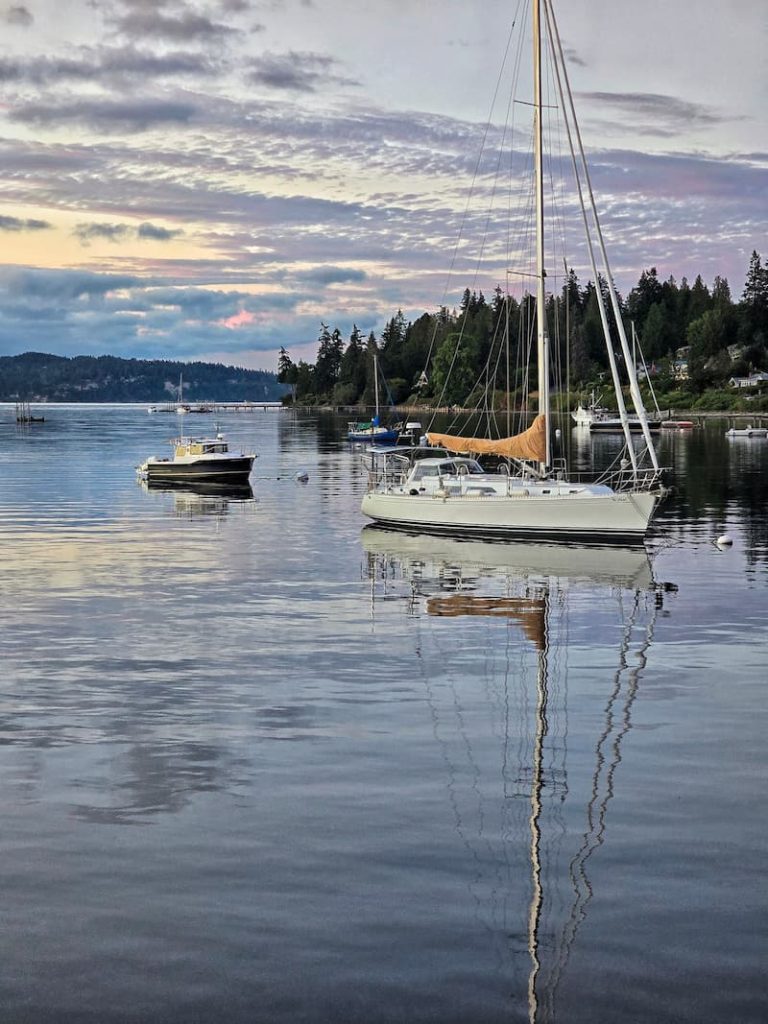 bay in Port Madison with boats anchored and colorful clouds in the sky