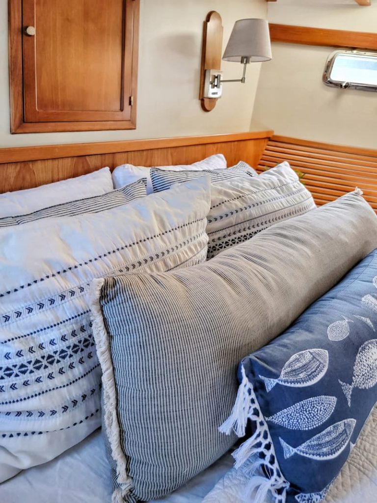 blue and white pillows on the boat bed