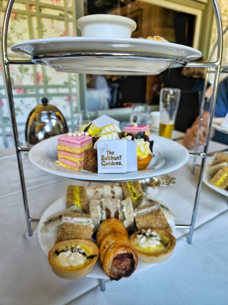 tea tray with sandwiches, pastries, and desserts