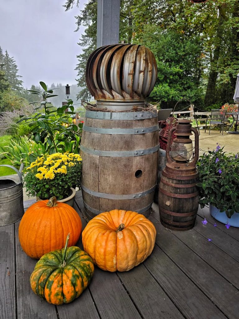 Outdoor Fall Decorating Ideas: wine barrel with pumpkins and mums and lanterns