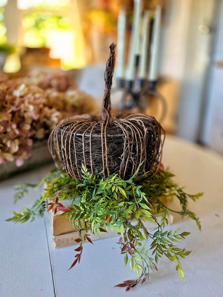 textured pumpkin with greenery underneath