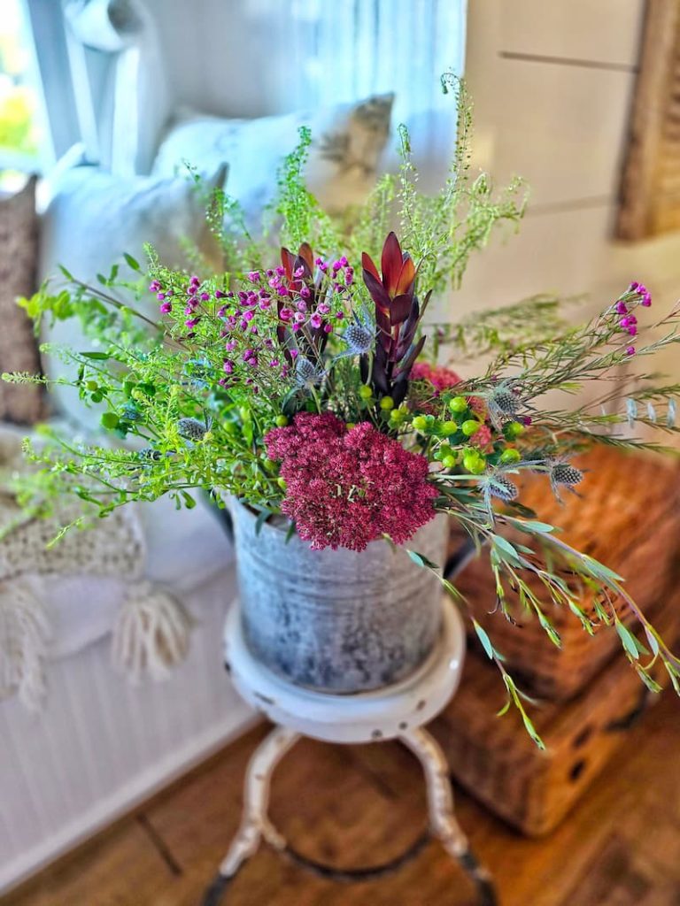 fall flowers inside a vintage galvanized bucket