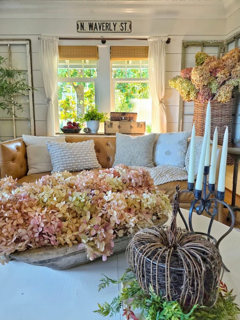 fall decor in cottage style living room with dried hydrangeas in wooden dough bowl