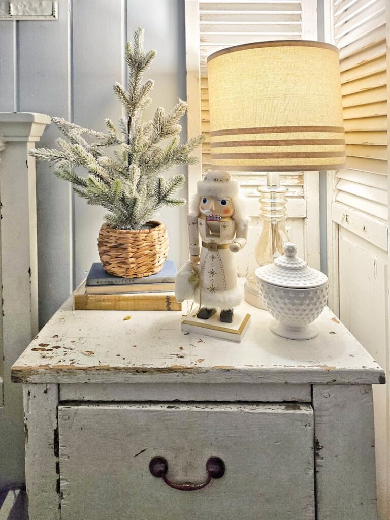 lamp, nutcracker, and mini tree on nightstand