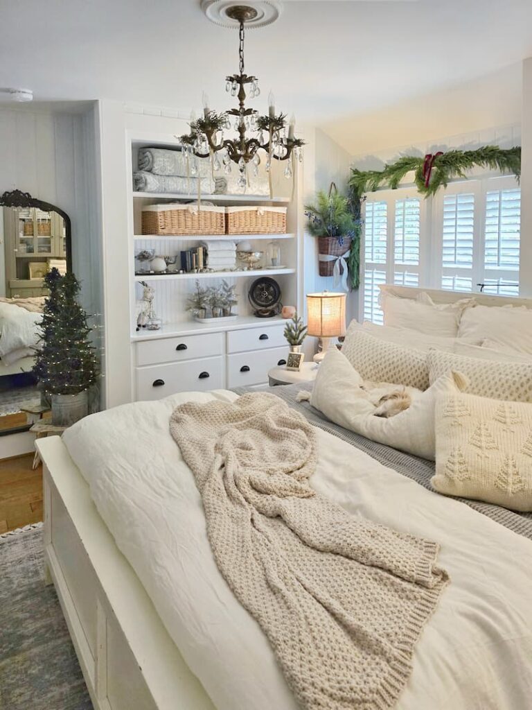 bedroom decorated for Christmas with Ollie napping on pillow