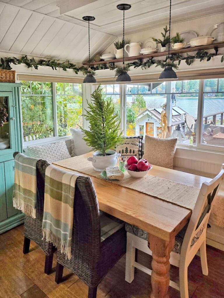 farmhouse table and plaid throws on the back of chairs 