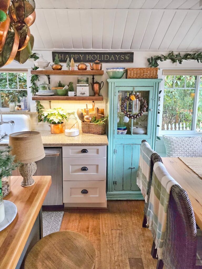 kitchen  with open shelving and aqua cabinet decorated for Christmas