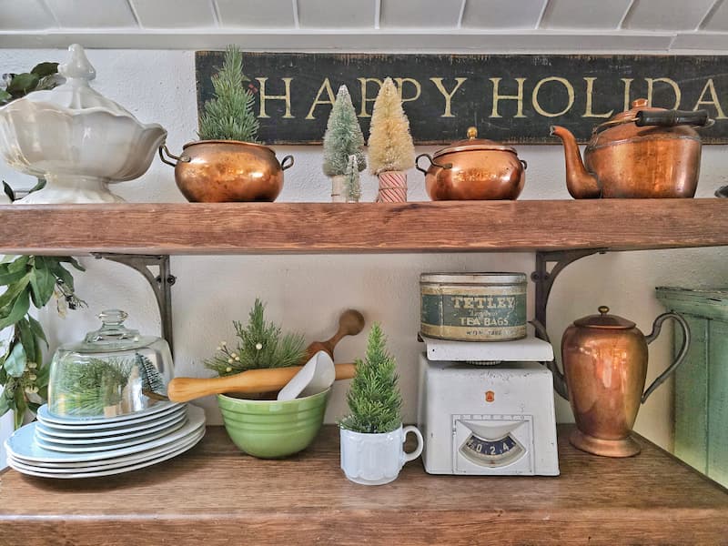 Christmas open shelving with copper accessories and vintage finds