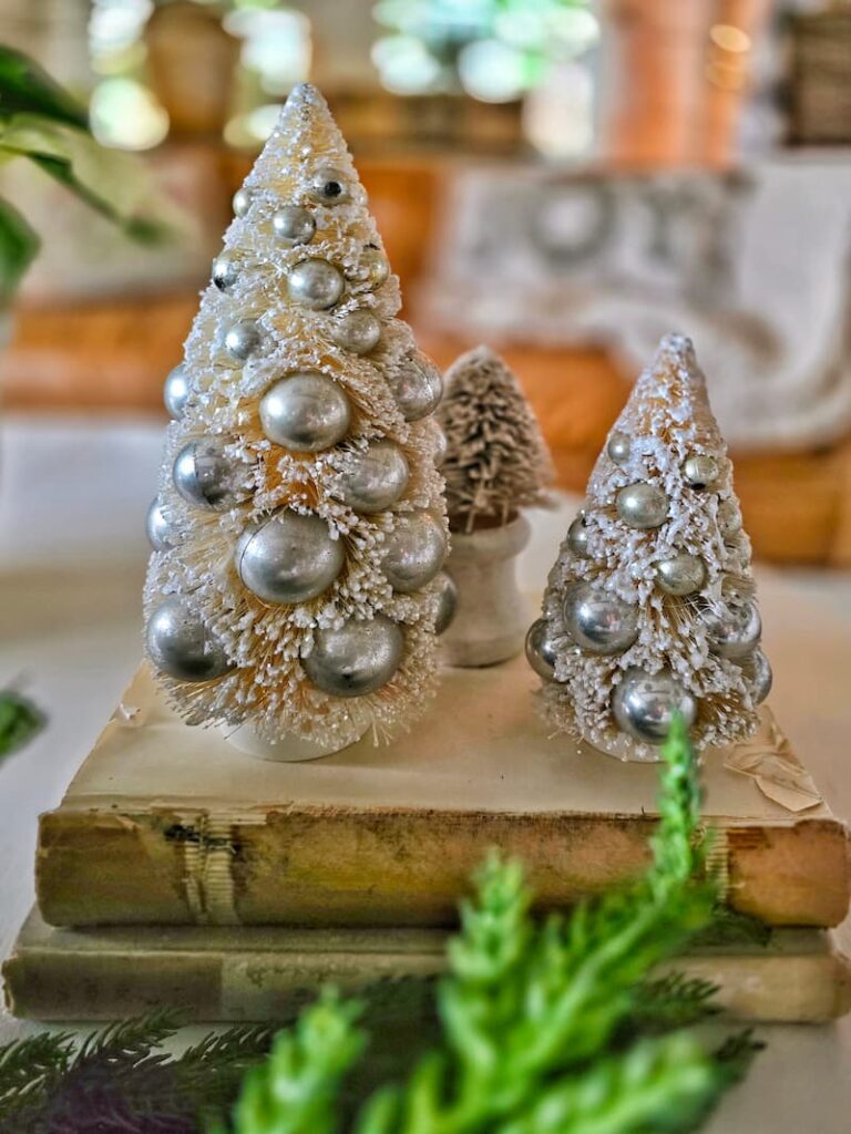 faux flocked brushed trees with silver baubles on vintage books