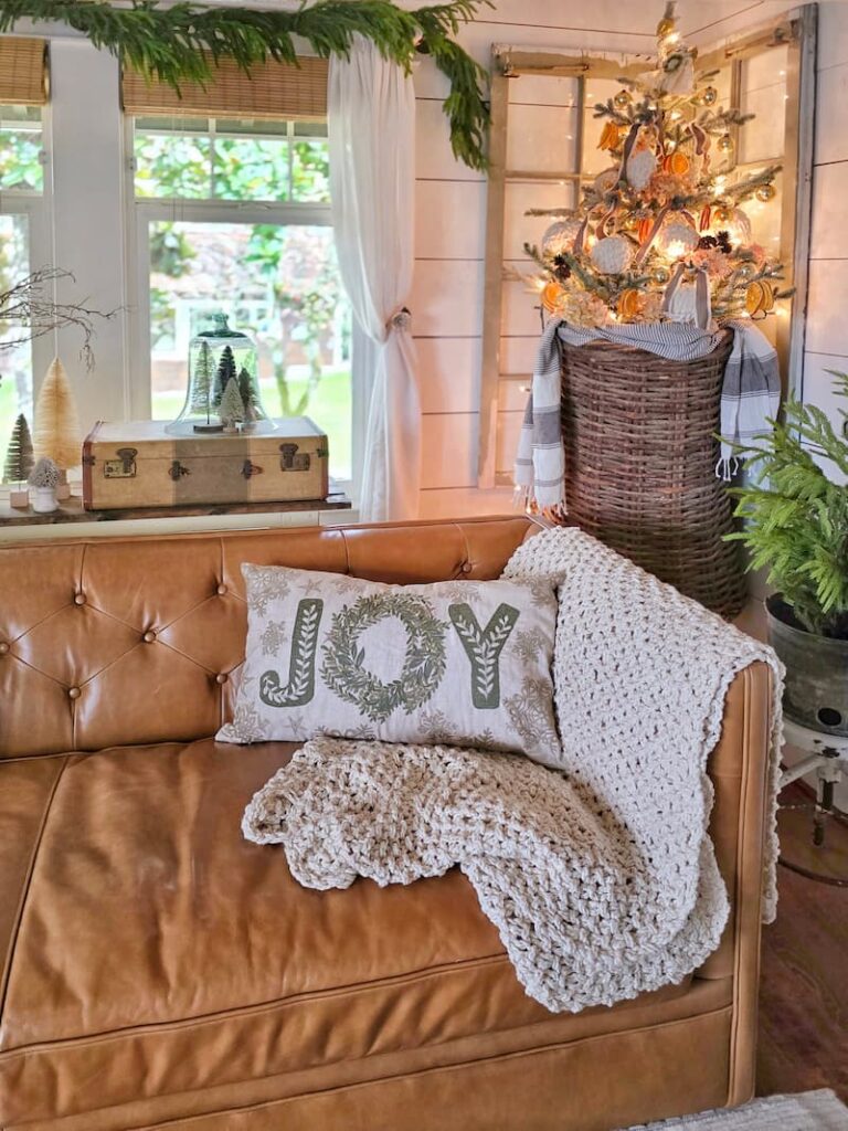 Embrace Christmas Charm with These Classic Decor Ideas: Joy pillow and Christmas tree on wall