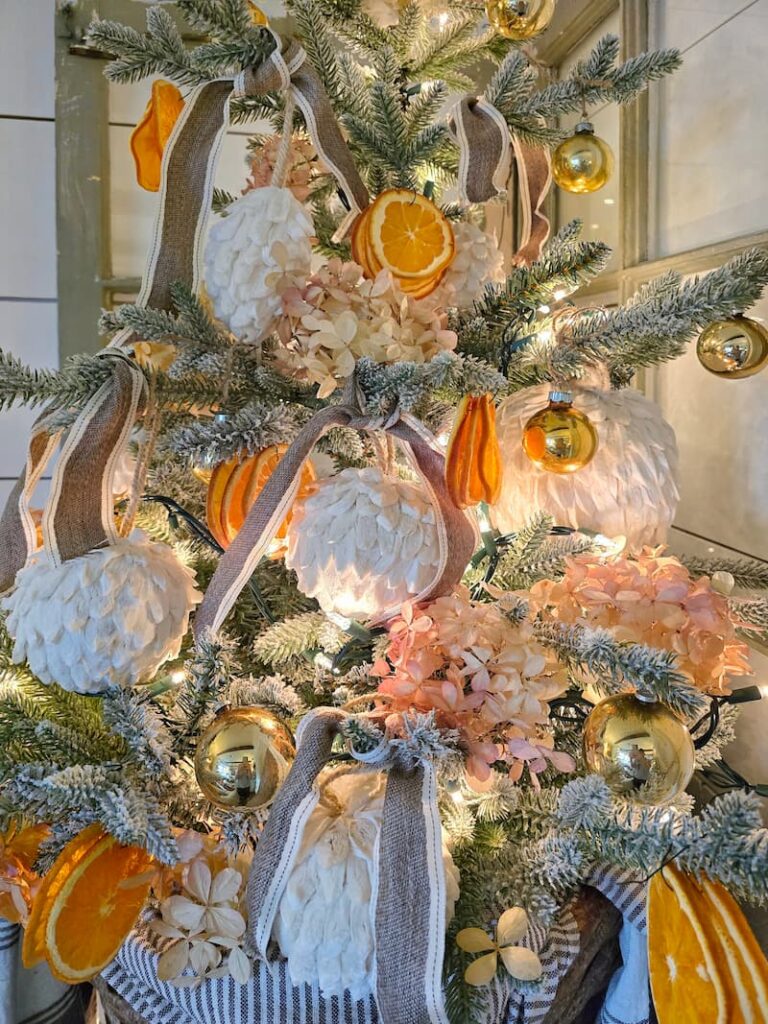 white textured ornaments and dried orange slices on the Christmas tree