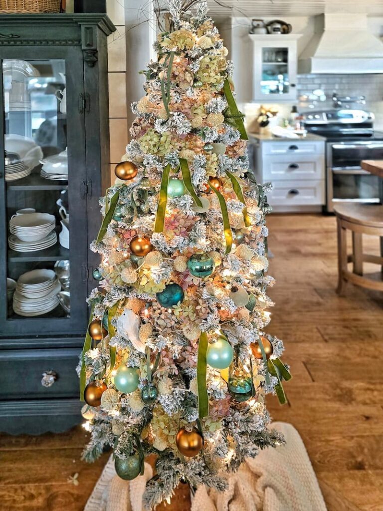 Christmas tree with blue, green, and copper ornaments