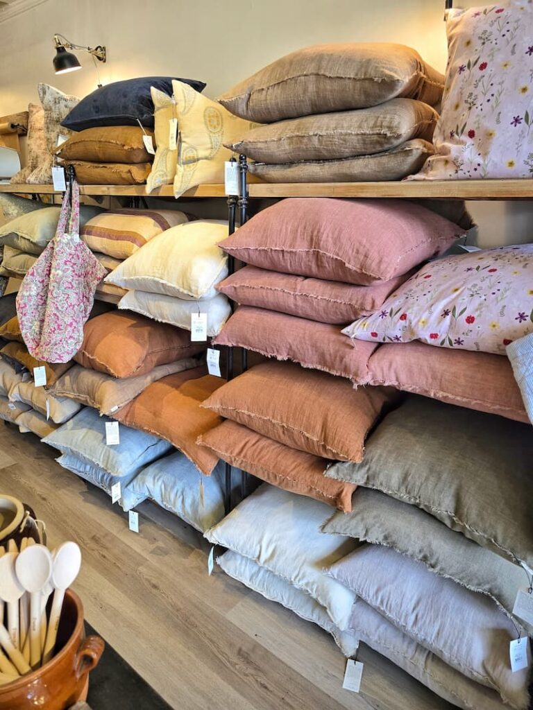 a wall of pillows in a store