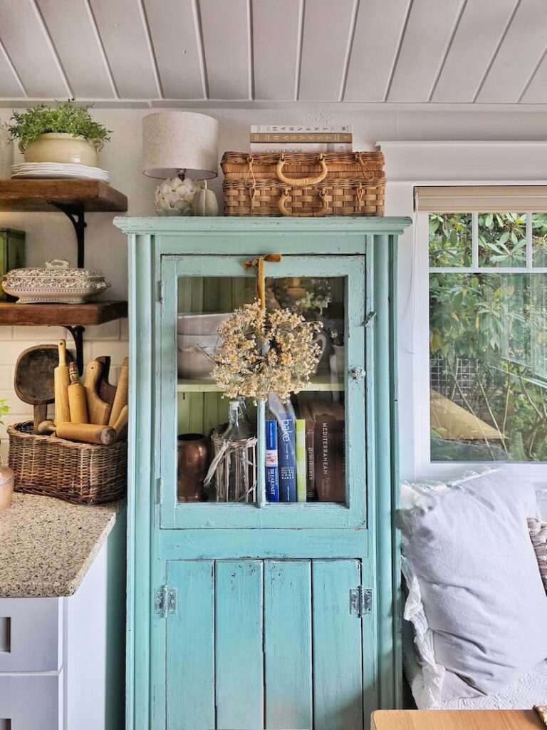 teal vintage cabinet in a cottage kitchen