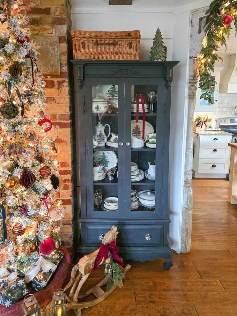 black cabinet with glass doors displaying Spode Christmas collection
