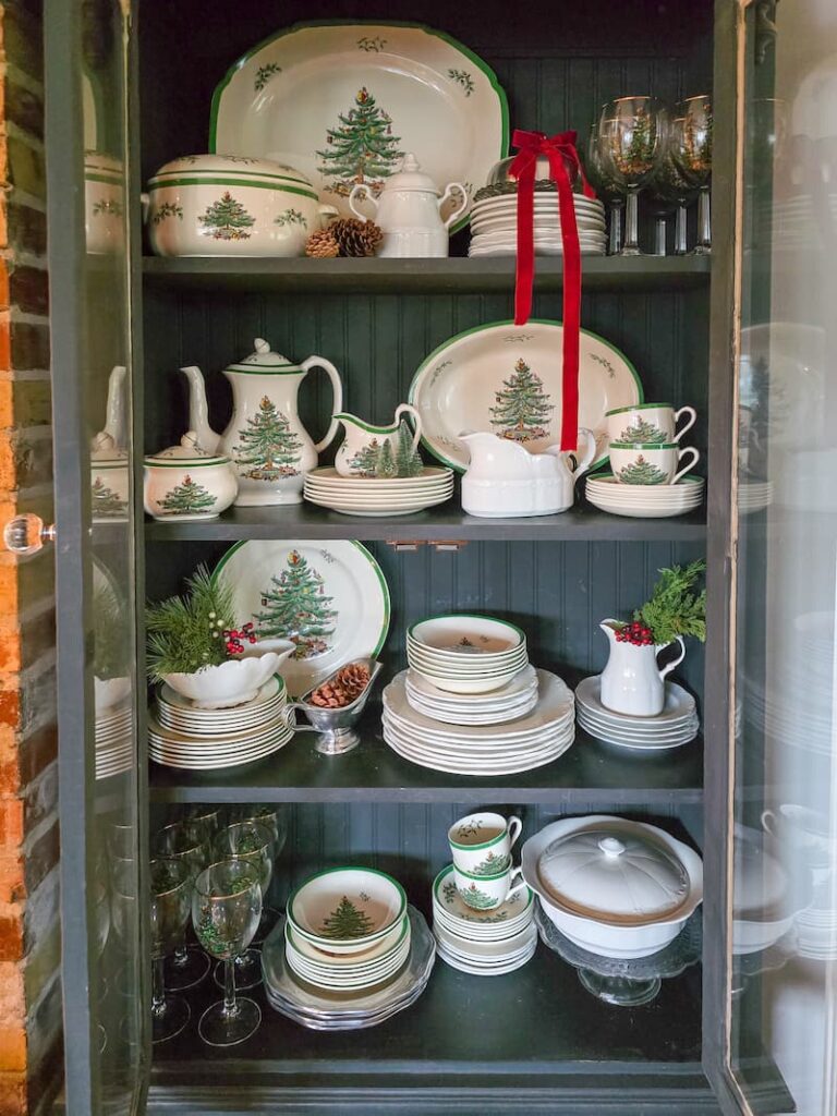black cabinet with glass doors displaying Spode Christmas collection