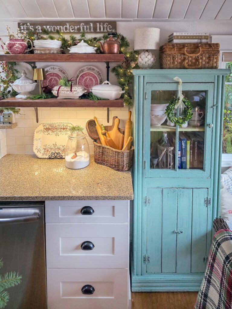 teal vintage cabinet and open shelving in kitchen with vintage transferware and ironstone