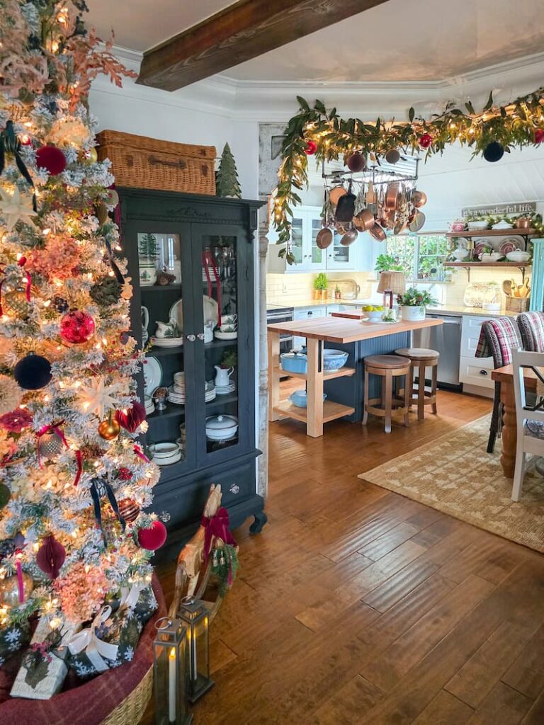 Moody theme Decorated Christmas tree in the living room and a view of the decorated kitchen