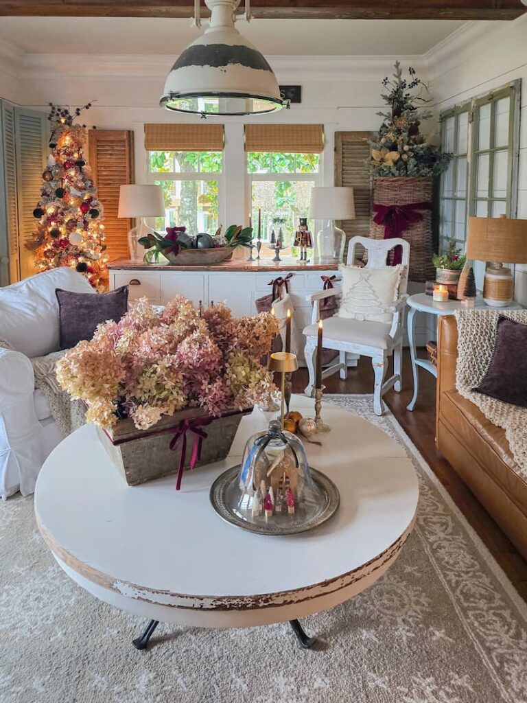 cottage living room decorated for Christmas and dried hydrangeas on the coffee table