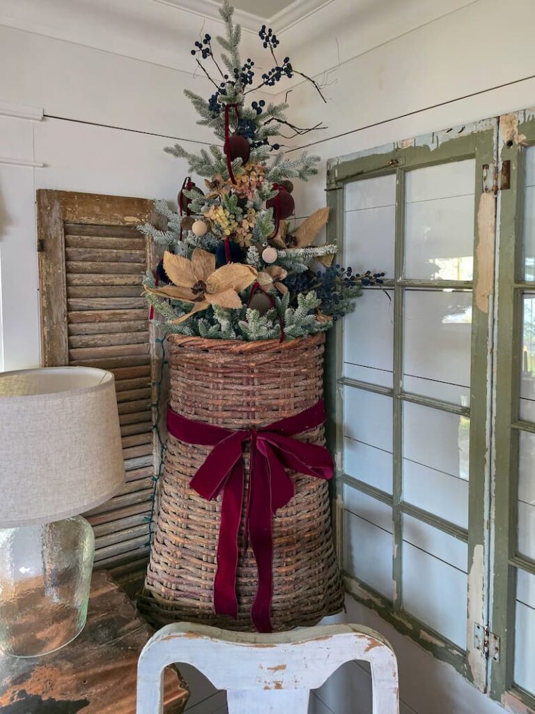 Decorated Christmas tree in a basket hanging on the wall in the living room