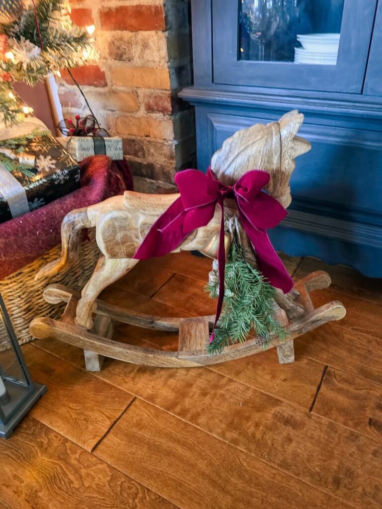 wooden ricking horse with a burgundy bow
