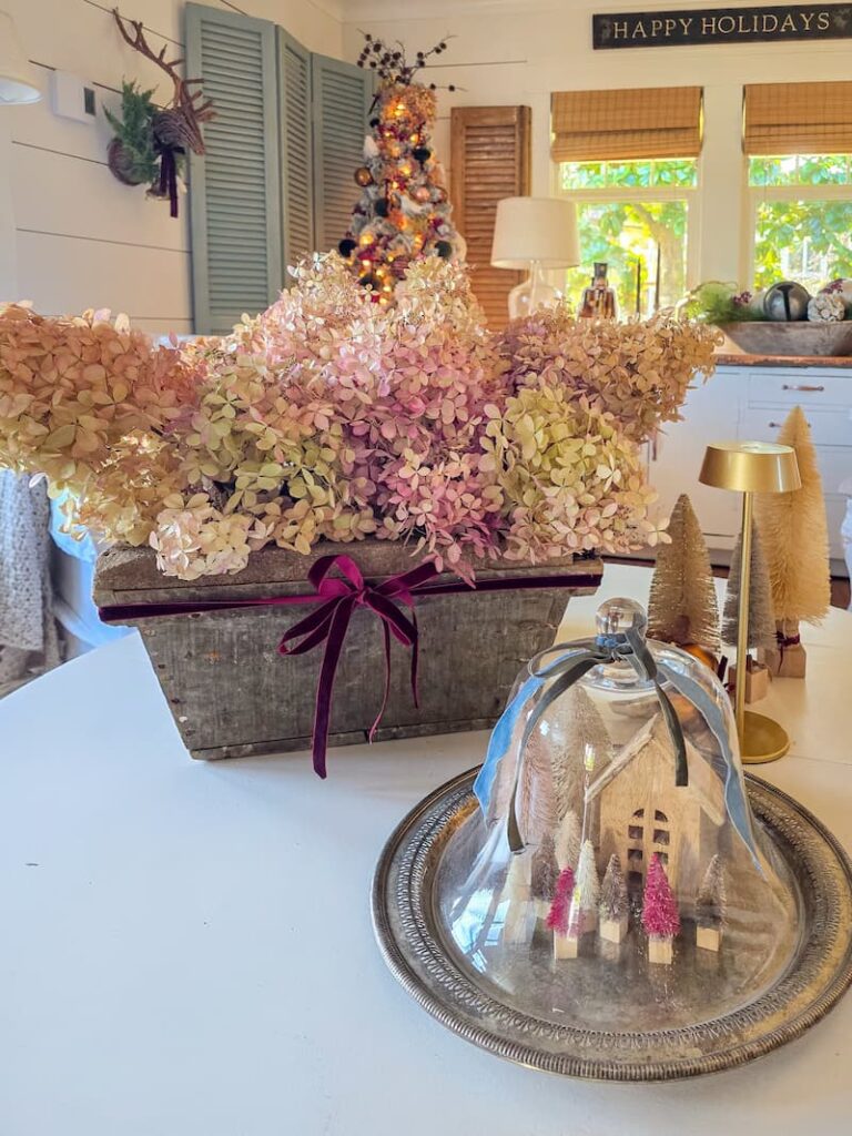 cottage living room decorated for Christmas and dried hydrangeas on the coffee table