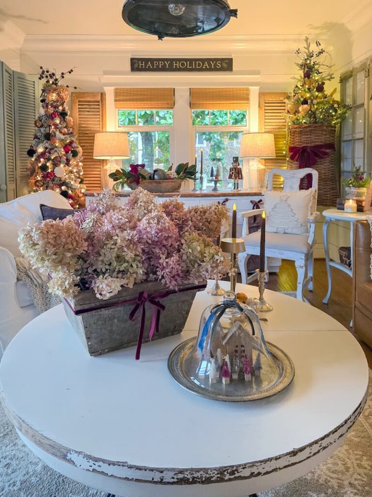cottage living room decorated for Christmas and dried hydrangeas on the coffee table