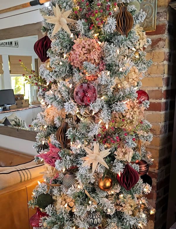 flocked Christmas tree decorated in darker colors
