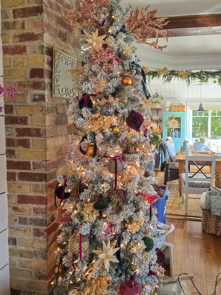 flocked Christmas tree decorated in darker colors