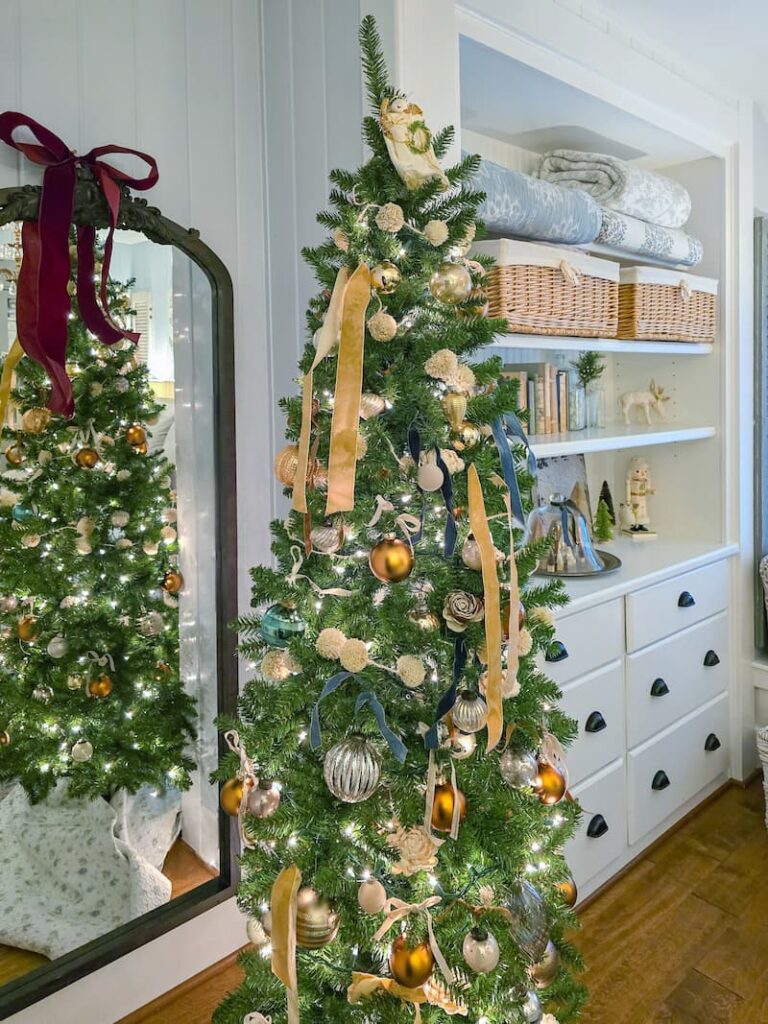 Pencil Christmas tree decorated in neutral colors in the bedroom