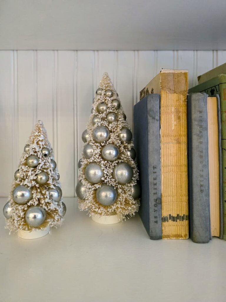 blue and cream vintage books and silver bottle brush trees with silver balls