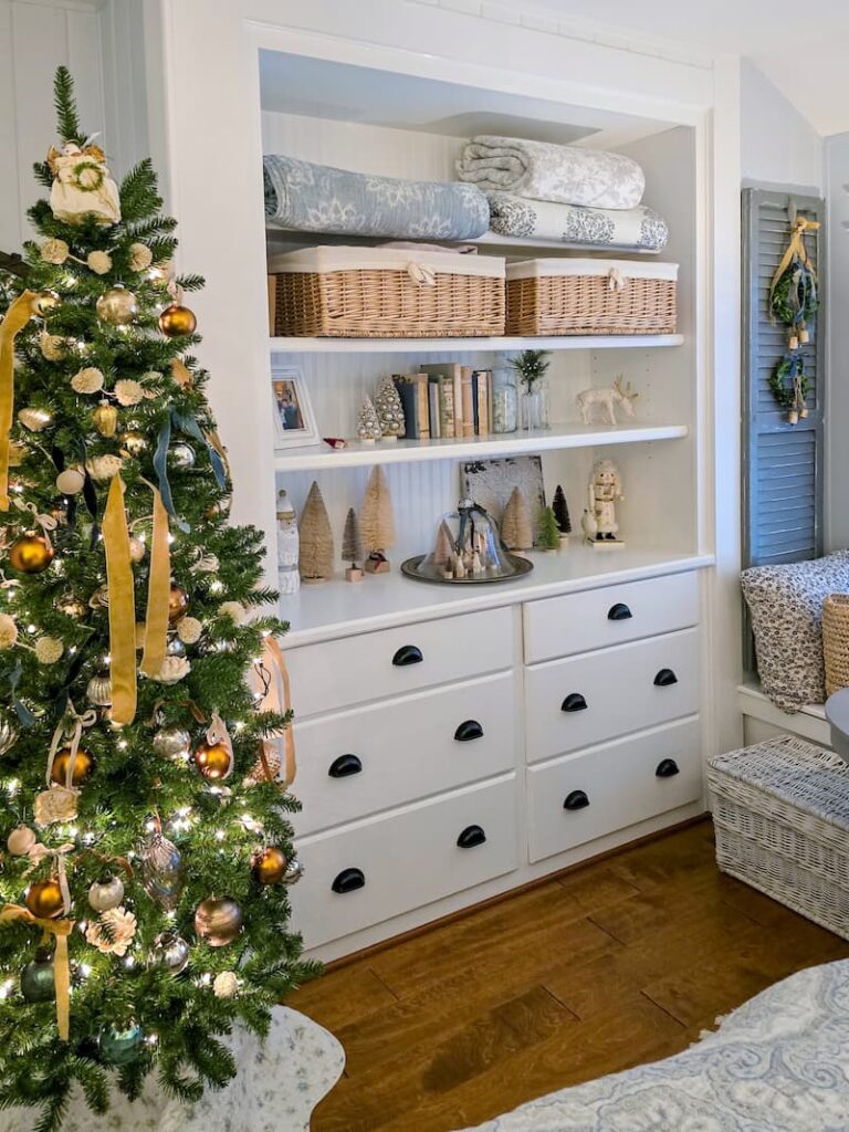 neutral colored Christmas tree and built-in with Christmas decor in cottage bedroom