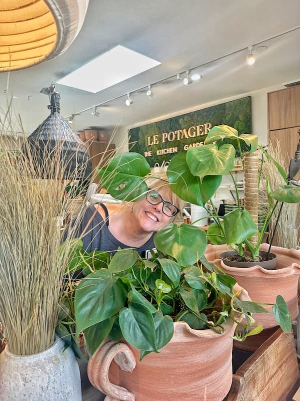 posing with the plants at the garden store