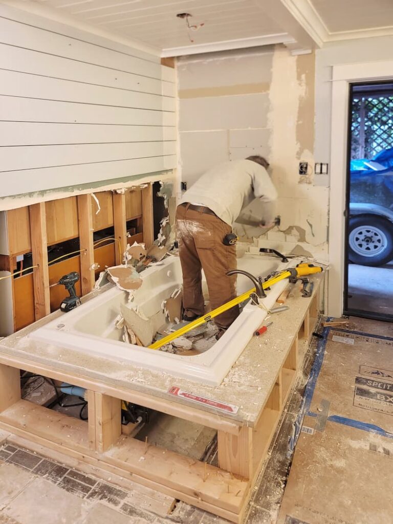 tearing out a tub in the bathroom