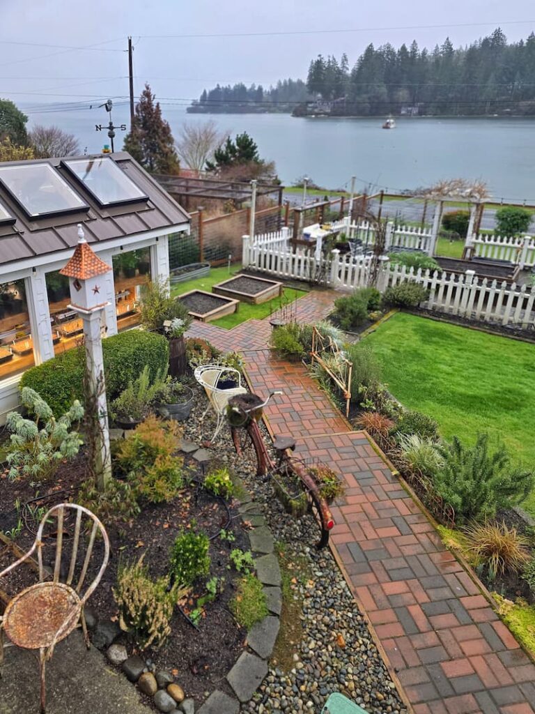 overview of the cottage garden in February with a view of the bay