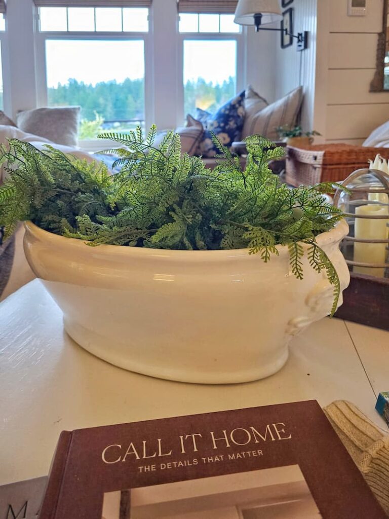 white ceramic container with faux ferns