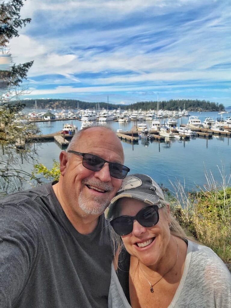 posing for a picture in front of the Roche Harbor Marina