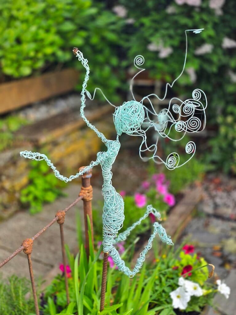 turquoise wire garden fairy in the garden
