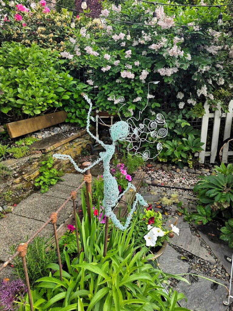 turquoise wire garden fairy in the cottage garden
