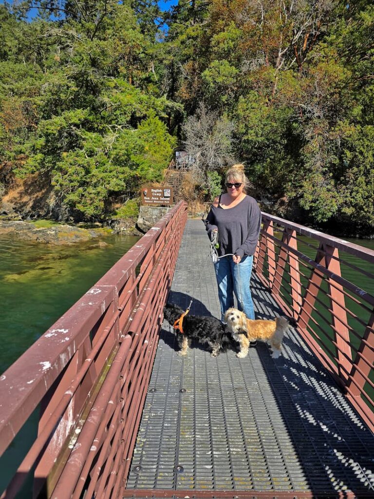 woman and dogs on ramp to English Camp on Garrison Bay