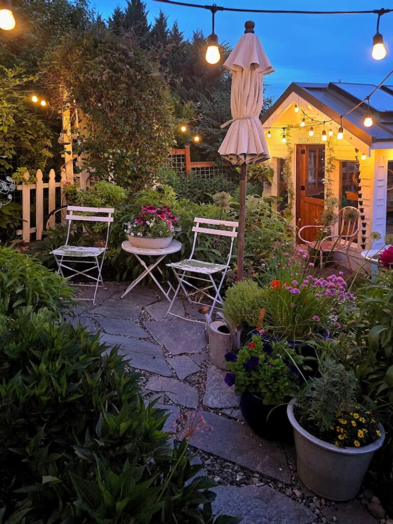 evening views with greenhouse and bistro table and chairs on patio